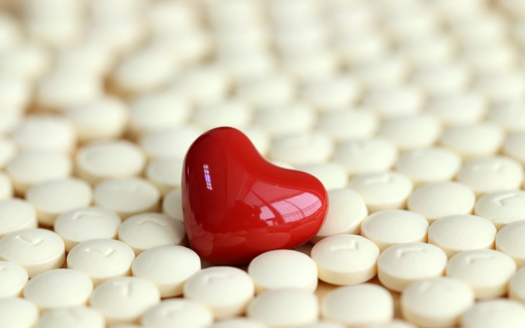 heart surrounded by pills